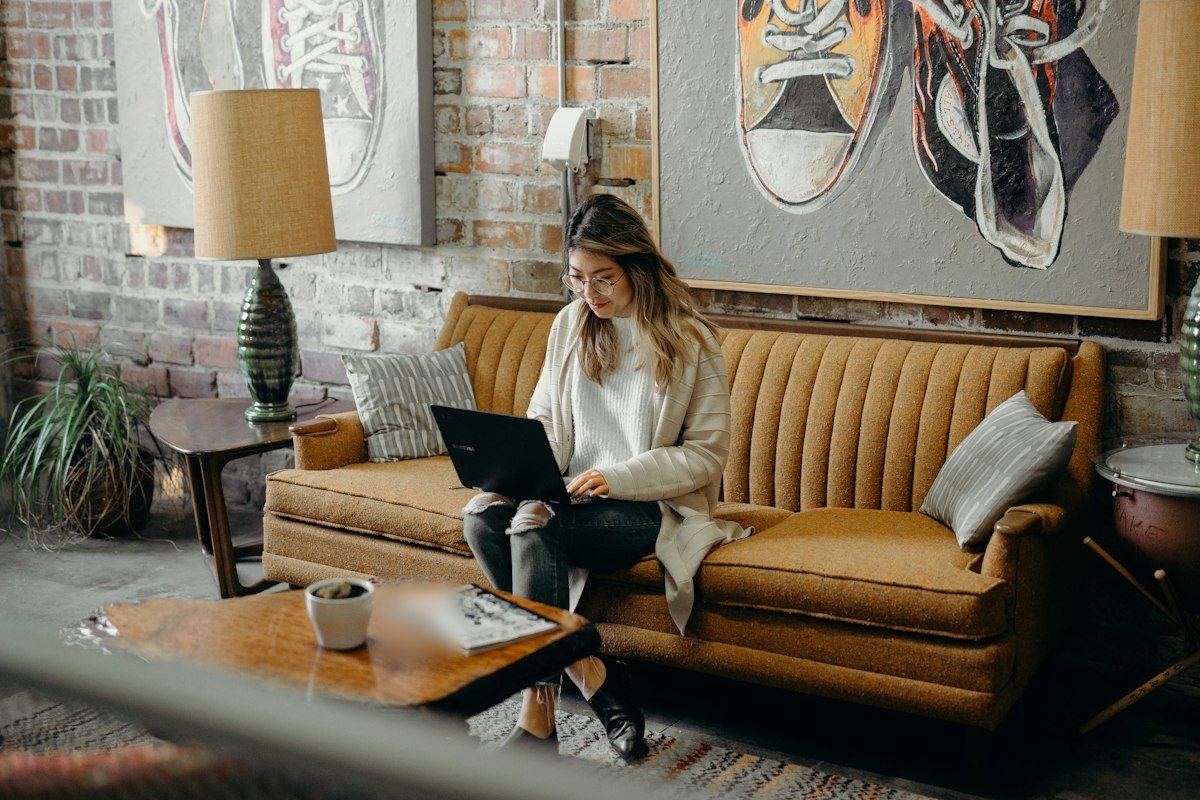 Woman reading on her laptop at home